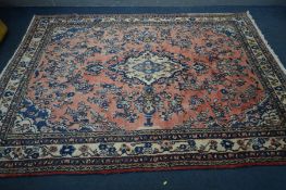 A WOOLLEN KASHAN RUG, red and cream ground, with a multi strap border, 316cm x 213cm