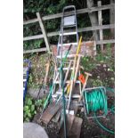 AN ALUMINIUM STEP LADDER, height 202cm and a selection of garden tools including a Stainless Steel