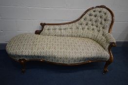 A VICTORIAN MAHOGANY CHAISE LONGUE, with floral upholstery, scrolled arms, cabriole legs on brass