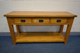 A SOLID OAK SIDE TABLE with three drawers, block legs united by an undershelf, width 150cm x depth