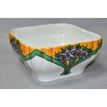 A MINTON LTD SECESSIONIST SQUARE BOWL, decorated with stylized purple flowers, with ochre and