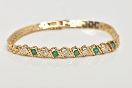 AN EMERALD AND DIAMOND BRACELET, centre section alternating round cut emeralds and diamonds each
