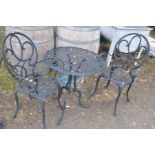 A BLACK PAINTED ALUMINIUM GARDEN TABLE AND TWO MATCHING CHAIRS with a 60cm diameter top with pierced