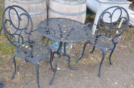 A BLACK PAINTED ALUMINIUM GARDEN TABLE AND TWO MATCHING CHAIRS with a 60cm diameter top with pierced