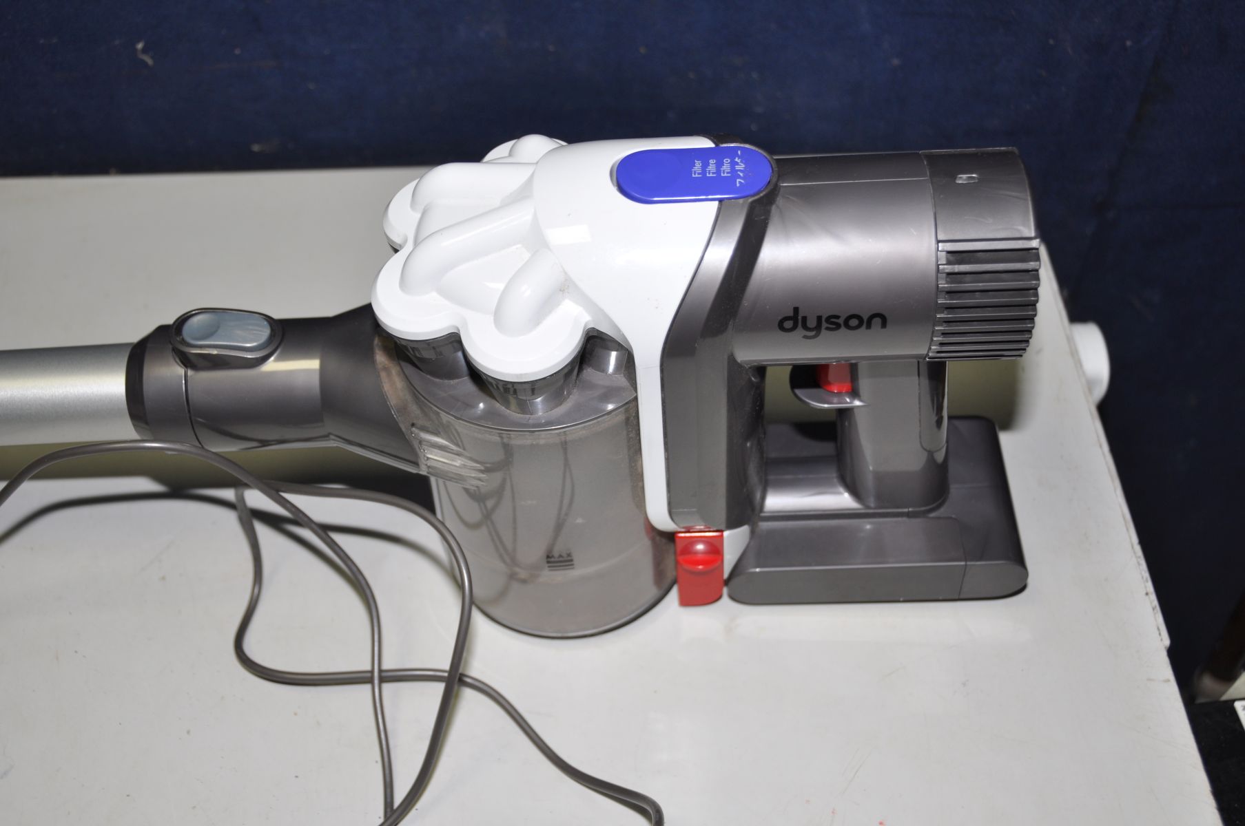 A DYSON DC44 HAND HELD CORDLESS VACUUM CLEANER with charger, wall rack and accessories (PAT pass and - Image 2 of 4