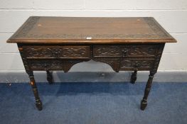 AN EARLY 20TH CENTURY CARVED OAK DESK/DRESSING TABLE, with four drawers, on turned legs, width 114cm