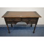 AN EARLY 20TH CENTURY CARVED OAK DESK/DRESSING TABLE, with four drawers, on turned legs, width 114cm