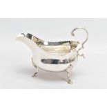 A GEORGE III SILVER GRAVY BOAT, with scalloped edge, scrolling handle and raised on step pad feet,
