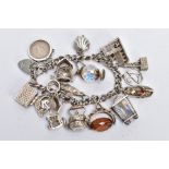 A CHARM BRACELET, the curb link bracelet suspending seventeen charms, to include a hinged shell
