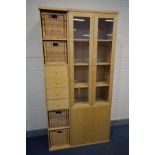 A MODERN BEECH GLAZED TWO DOOR BOOKCASE above a single cupboard door, width 72cm x depth 40cm x