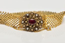 A GEORGIAN GLD GARNET AND SEED PEARL BRACELET, composed of trellis work links to an oval flat