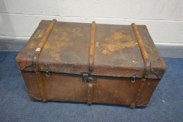 A VINTAGE TRAVELLING TRUNK, wooden and metal banded with twin handles, width 87cm x depth 56cm x