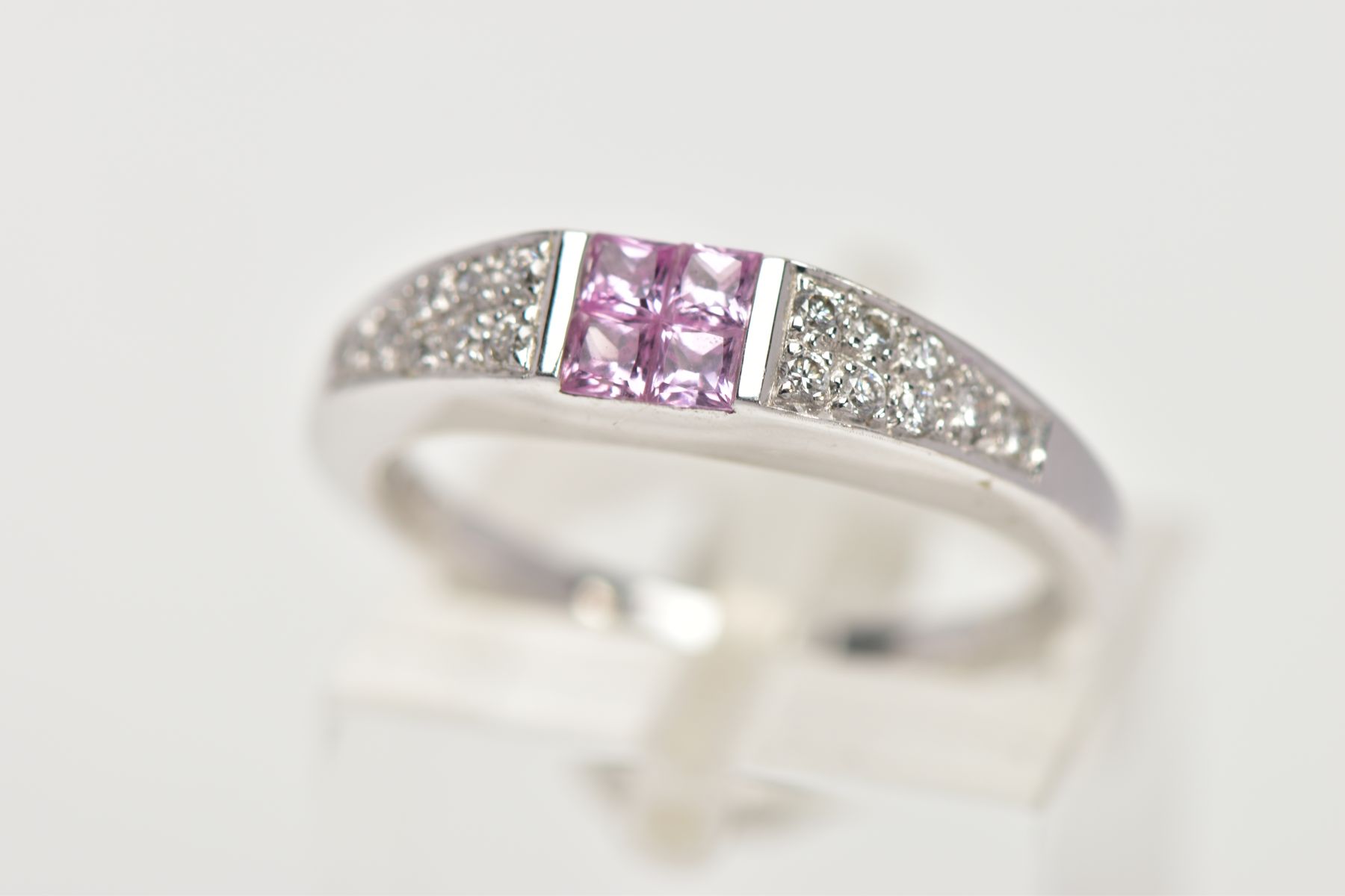 A MODERN 18CT WHITE GOLD PINK SAPPHIRE AND DIAMOND DRESS RING, centring on four square cut pink