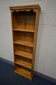A TALL SLIM PINE OPEN BOOKCASE with four fixed shelves, width 60cm x depth 25cm x height 180cm
