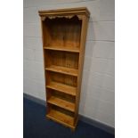 A TALL SLIM PINE OPEN BOOKCASE with four fixed shelves, width 60cm x depth 25cm x height 180cm