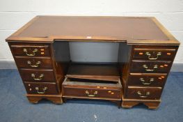 A LATE 19TH/20TH CENTURY MAHOGANY PEDESTAL DESK, inverted breakfront, and nine assorted drawers,