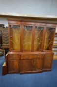 A MAHOGANY BREAKFRONT FOUR DOOR BOOKCASE, with a single secretaire drawer, width 182cm x depth