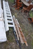 A VINTAGE WOODEN STEP LADDER height 141cm and a wooden triple extension ladder with eleven rungs