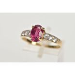 A MODERN RUBY AND WHITE SAPPHIRE DRESS RING, an oval ruby measuring 8.5mm x 6.0mm x 3.0mm, estimated