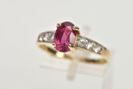 A MODERN RUBY AND WHITE SAPPHIRE DRESS RING, an oval ruby measuring 8.5mm x 6.0mm x 3.0mm, estimated