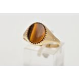 A 9CT GOLD TIGERS EYE SIGNET RING, a central oval tigers eye panel to the tapered band with diagonal