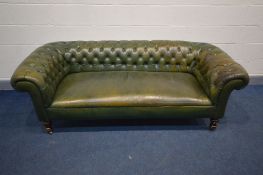 A VICTORIAN GREEN LEATHER CHESTERFIELD SEETEE, sprung seated on mahogany turned legs (condition -