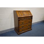 AN OAK OLD CHARM BUREAU, linenfold fall front above four long drawers, width 75cm x depth 48cm x