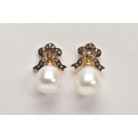 A PAIR OF YELLOW METAL, CULTURED PEARL AND DIAMOND DROP EARRINGS, each designed with bow shaped