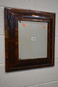 A WILLIAM AND MARY OYSTER WALNUT VENEERED CUSHION MOULDED WALL MIRROR, with stained pine