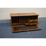 AN OAK TABLE TOP SECRETAIRE CABINET, with a fall front door with internal Burgandy leather inlay