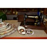 A MECHANICAL SINGER SEWING MACHINE WITH WOODEN CASE, together with a graduated set of platters,