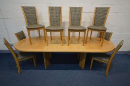 A SKOVBY LIGHT OAK EXTENDING DINING TABLE with rounded ends, with two single leaves, open width