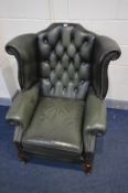 A GREEN LEATHER BUTTON BACK WINGBACK CHAIR on cabriole legs, width 90cm x depth 87cm x height