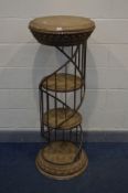 A CYLINDRICAL RESIN SHOP DISPLAY STAND, with a wrought iron gallery spiralling around three tier