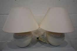 A PAIR OF CREAM CERAMIC TABLE LAMPS with shades