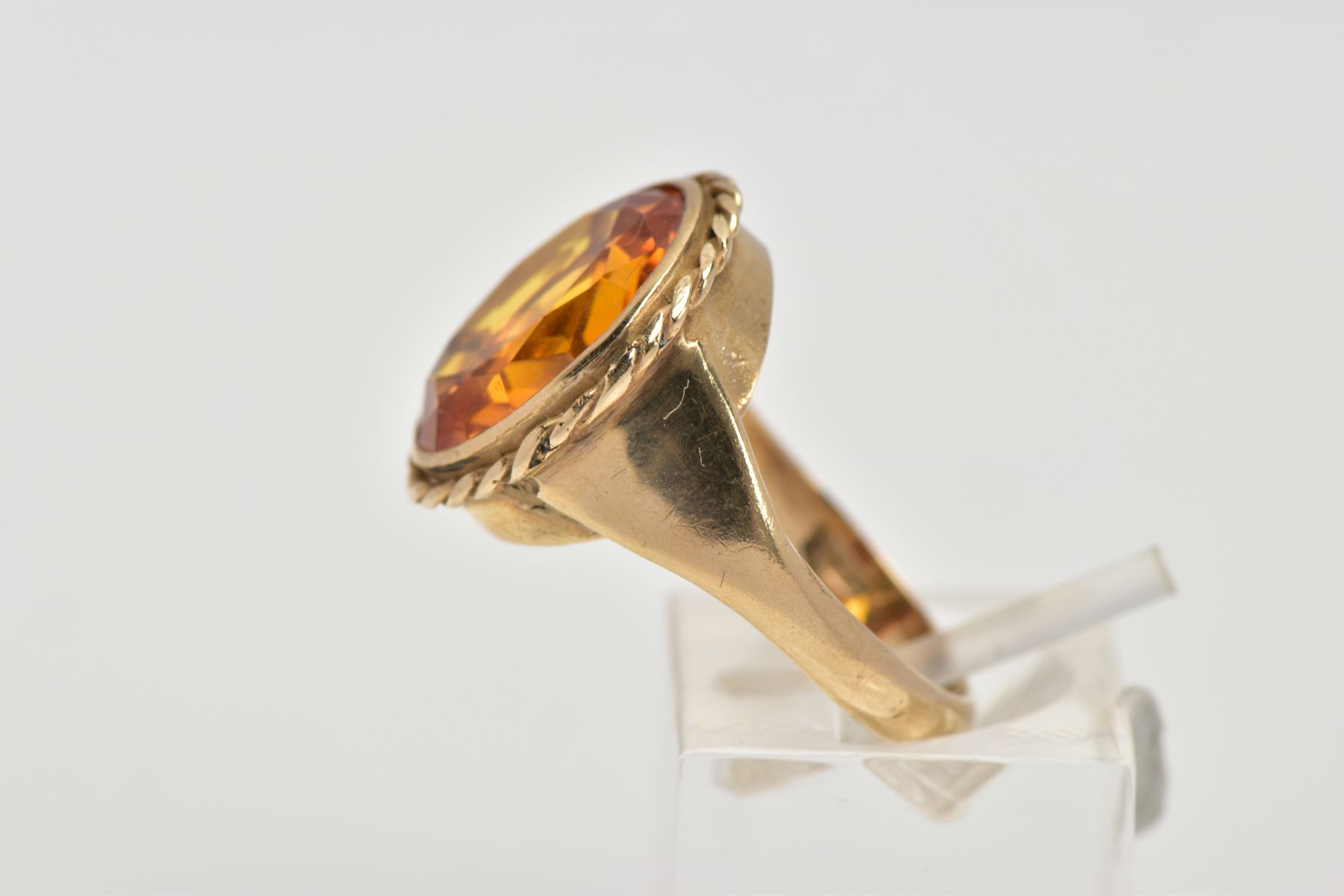 A 9CT GOLD SYNTHETIC ORANGE SAPPHIRE DRESS RING, designed with a large oval cut synthetic orange - Image 2 of 4