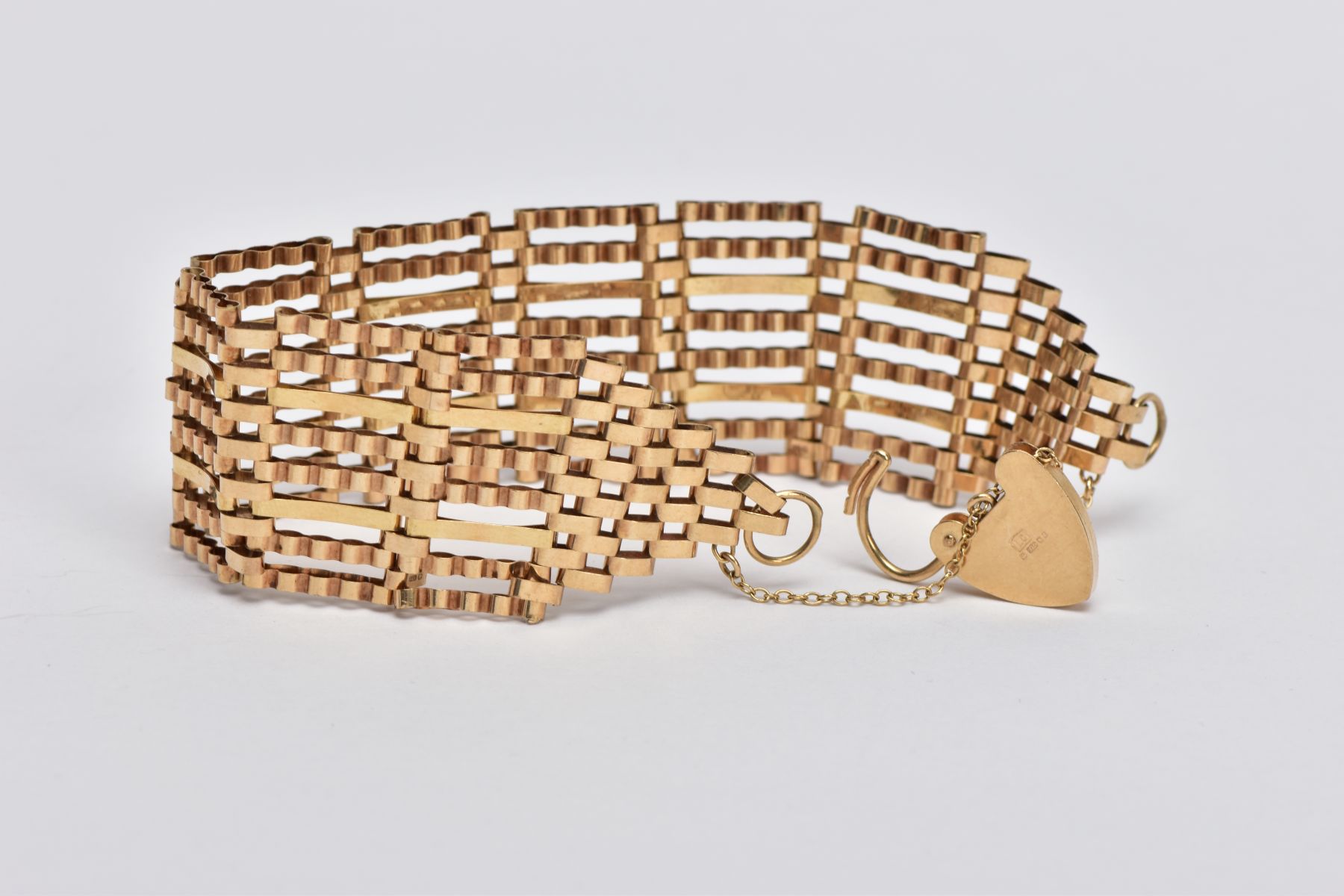 A 9CT GOLD WIDE GATE BRACELET, the gate bracelet with graduated terminals to the heart padlock clasp - Image 3 of 3