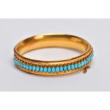 A LATE VICTORIAN TURQUOISE HINGED BANGLE, of slight concave design, the back half with central