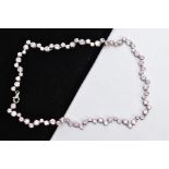 A SILVER CUBIC ZIRCONIA NECKLET, the full chain set with alternating sizes of circular cut, pink
