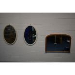 A PINE OVERMANTEL MIRROR, 102cm x 76cm and a pair of painted oval bevelled edge wall mirrors (3)