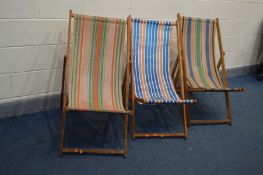 A SET OF THREE 1970'S FOLDING DECK CHAIRS with stripped fabric