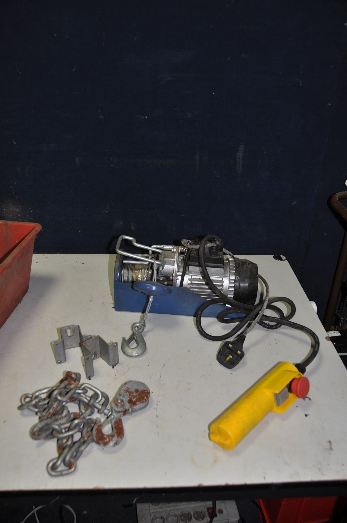 A POWERCRAFT ELECTRIC WINCH 240v (PAT pass and working) along with a chain and shackle and a hand