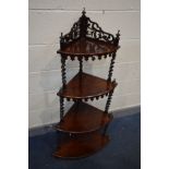 A VICTORIAN ROSEWOOD FOUR TIER WHAT NOT, raised pierced back, barley twist supports, finials and