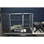 A WIRE FRAME DOG PEN with plastic base open top and single door width 108cm depth 73cm and 70cm