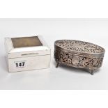 A GEORGE V SILVER LINED, SQUARE CIGARETTE BOX AND A PIERCED OVAL VANITY BOX, engine turned design