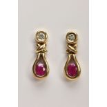 A PAIR OF 9CT GOLD RUBY AND DIAMOND EARRINGS, each drop set with an illusion set single cut diamond,