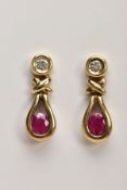 A PAIR OF 9CT GOLD RUBY AND DIAMOND EARRINGS, each drop set with an illusion set single cut diamond,
