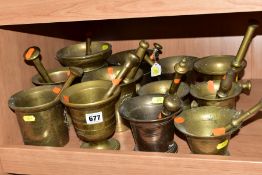 TWELVE ASSORTED BRASS PESTLES AND MORTARS, one in bronze/gun metal, various designs, tallest 15cm,