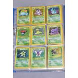 A QUANTITY OF POKEMON CARDS - over four hundred cards of various sets including Base Set, Fossil