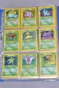 A QUANTITY OF POKEMON CARDS - over four hundred cards of various sets including Base Set, Fossil